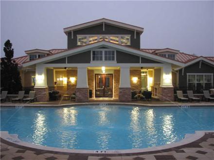 Sparkling pool with clubhouse exterior Sparkling pool with clubhouse exterior