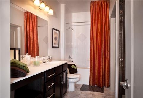 Large bathrooms with ceramic tile floors feature large vanities and garden tubs Large bathrooms with ceramic tile floors feature large vanities and garden tubs