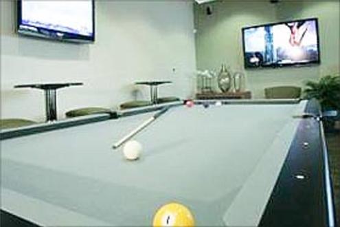 Game room with flat screen TVs and billiards table Game room with flat screen TVs and billiards table