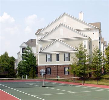 Full size tennis court with residence exterior Full size tennis court with residence exterior