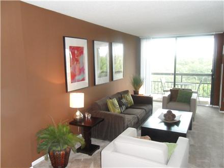 Living room with floor to ceiling sliding doors to balcony